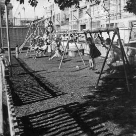 Children playing on swings at Woolloomooloo.