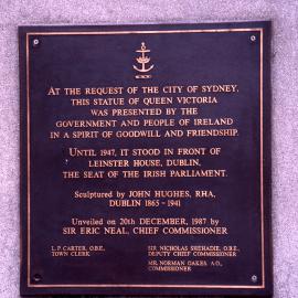 Plaque on statue of Queen Victoria.