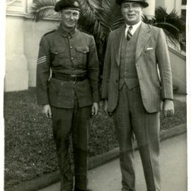 Street photograph of soldier and man in business suit, circa 1940-1942