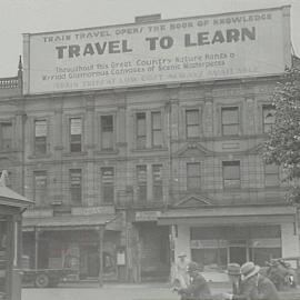 Three story brick building featuring 'Travel to learn' advertisement, Pitt Street Sydney, 1935