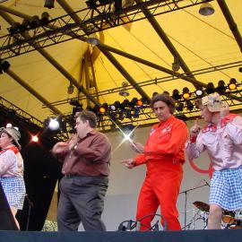 Topp Twins, Sandman and Mikey Robbins on stage at the Domain Olympic Live Site, Sydney, 2000