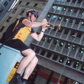 Busker playing a bugle at the corner of Pitt and Hunter Streets, Sydney, 2000