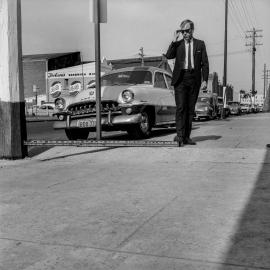 Measuring level of footpath, Botany Road Alexandra, 1965