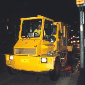 Street cleaner in action at night on Elizabeth Street, Sydney, 2000