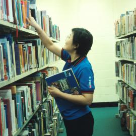 Staff member reshelving books at Ultimo Library, Ultimo Community Centre, Ultimo, 2000