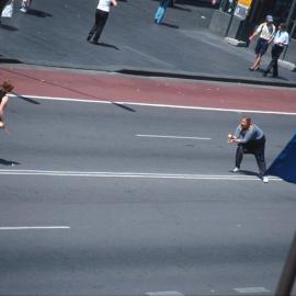 Spectators throwing ball on George Street, Sydney, 2000