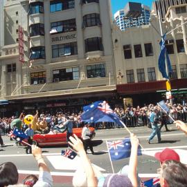 Waving hands as the Olympic Athletes parade passes by on George Street, Sydney, 2000