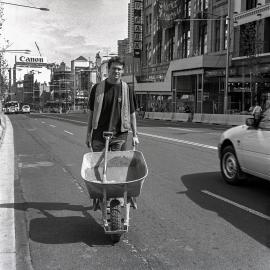 Workman pushing a wheelbarrow, George Street, 1998