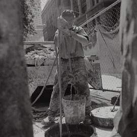 Workman on the footpath upgrade project, George Street Sydney, 2000