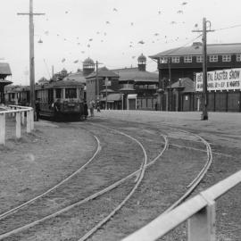 Trams in Driver Avenue alongside Royal Agricultural Society NSW buildings, Moore Park, 1957