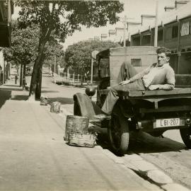 A man reclines on the back of truck in Arthurs Street Surry Hills, 1932.