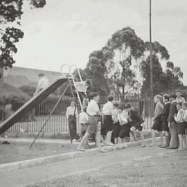 Boys queueing for the slide at Moore Park, Children's Playground Moore Park, 1936