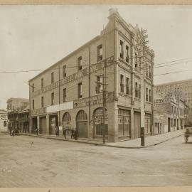 Print - Streetscape with commercial businesses, corner of Hay and Sussex Street Haymarket, 1910