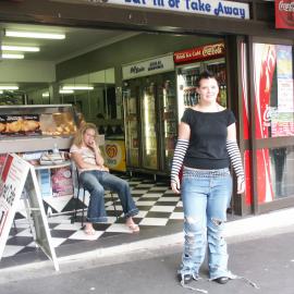 Eat In or Take Away a woman stands in front of 'Archies', Glebe Point Road Glebe, 2003
