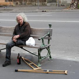 A man sitting on bench with crutches and a beer bottle, Glebe Point Road Glebe, 2002