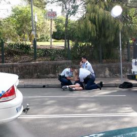 Man resisting arrest outside the Dr H.J. Foley Rest Park, Glebe Point Road Glebe, 2003