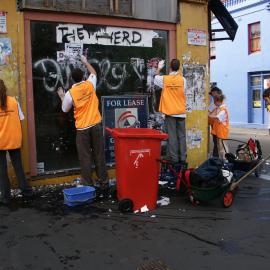 Team of cleaners working on a shopfront, Glebe Point Road Glebe, 2003