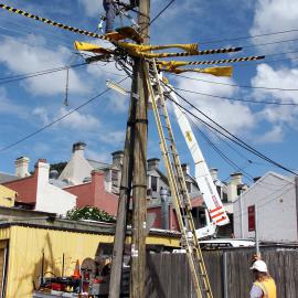 Workers installing a new power pole in Glebe Point Road Glebe, 2003