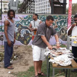 Carving the meat to share at the farewell to Auntie Joyce Ingram, Eveleigh Street Redfern, 2004