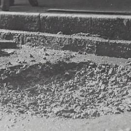 Damaged road surface Castlereagh Street Sydney, 1932