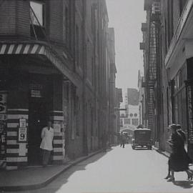 Women crossing the road near the barber shop on Central Street Sydney, 1935