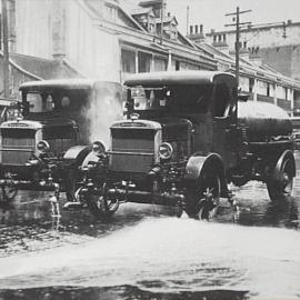 Council street flushing trucks in operation, location unknown, 1928