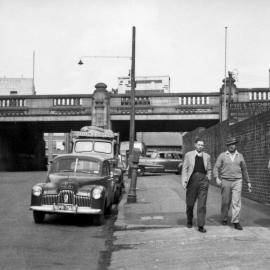 Three men walking along Day Street Sydney, circa 1930
