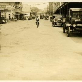 Trucks, cars and trams, George Street West, between Wattle and Mountain Streets Broadway, 1930