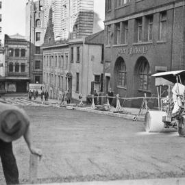View showing workers and steam roller resurfacing, Grosvenor Street, Sydney, 1936