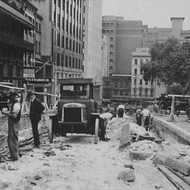 View east to George Street of workmen resurfacing Margaret Street Sydney, Sydney