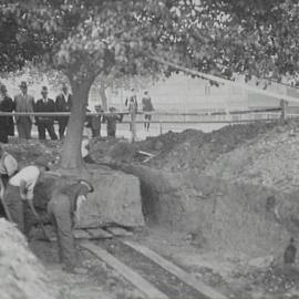 Onlookers watch reconstruction of Hyde Park South, College Street Sydney, 1933