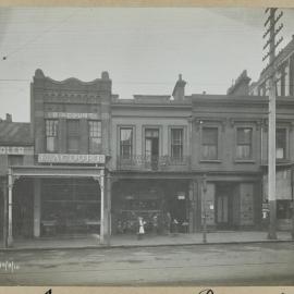 Print - Saddler with businesses on Oxford Street Darlinghurst, 1910