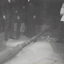 Crowd standing around light pole damaged by motor car, Macquarie Street Sydney, 1932