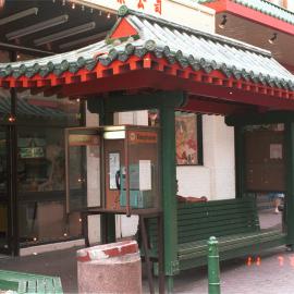 Covered public telephone and seating with pagoda style roof, Dixon Street Haymarket, 1985