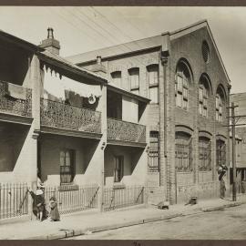 Print - Streetscape with terrace houses and White and Sons boot factory, Hutchinson Street Surry Hills, 1916