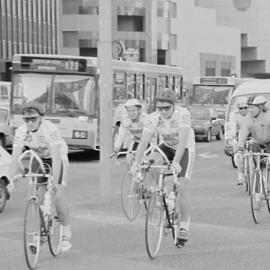 Bicycle couriers on the footpath in front of Town Hall, George Street Sydney, 1990