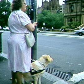 Woman using Braille street signs opposite Sydney Town Hall, George Street Sydney, 1993