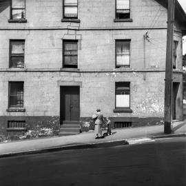 Woman and child walking past 16 Argyle Place, Millers Point, 1951