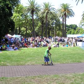 Child riding a scooter, stalls and picnickers at Yabun, Redfern Park Redfern, 2005