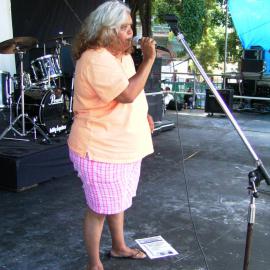 A female speaker on stage at Yabun, Redfern Park Redfern, 2005