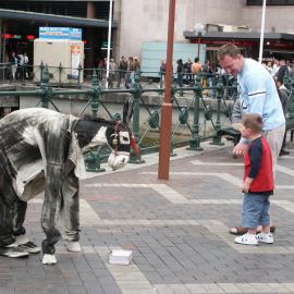 Buskers, boy watches person dressed as a horse, West Circular Quay pedestrian concourse Sydney, 2004
