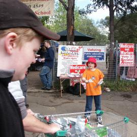 Buskers,  child hands out political pamphlets, corner Derby Place and Glebe Point Road, Glebe, 2004