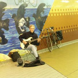 Buskers, man plays guitar seated in front of mural, Devonshire Street Tunnel Surry Hills, 2004