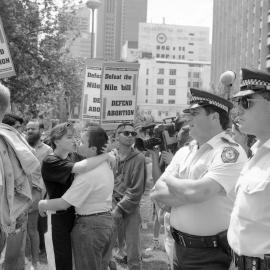 Lesbians kiss at the protest against Reverend Fred Nile's anti-abortion bill, Elizabeth Street Sydney, 1991