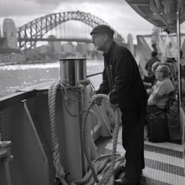 Ferry man adjusts ropes, Circular Quay Sydney, 2001