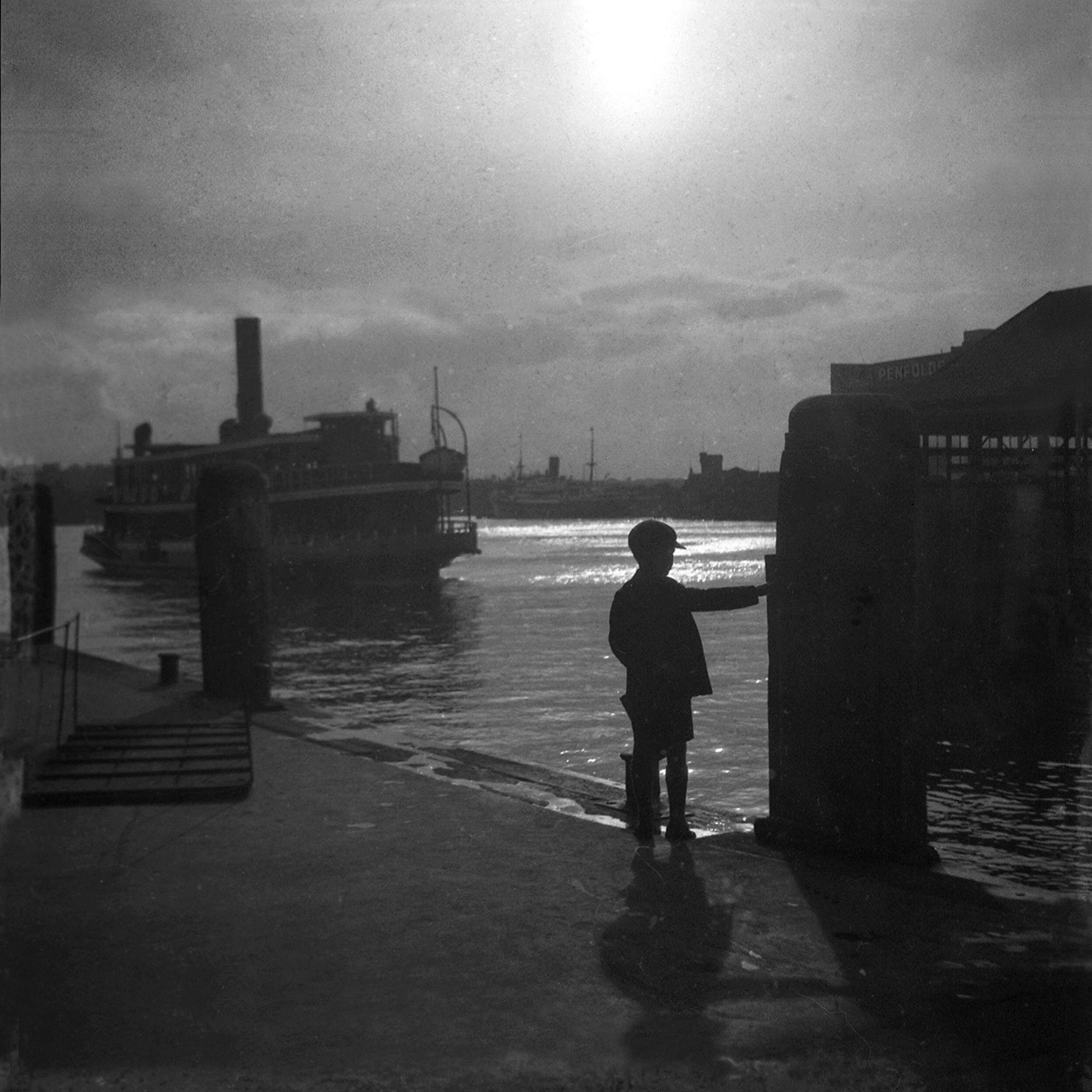 Boy waiting for ferry at Circular Quay, 1932 by Adam Forrest Grant (A-00025778)