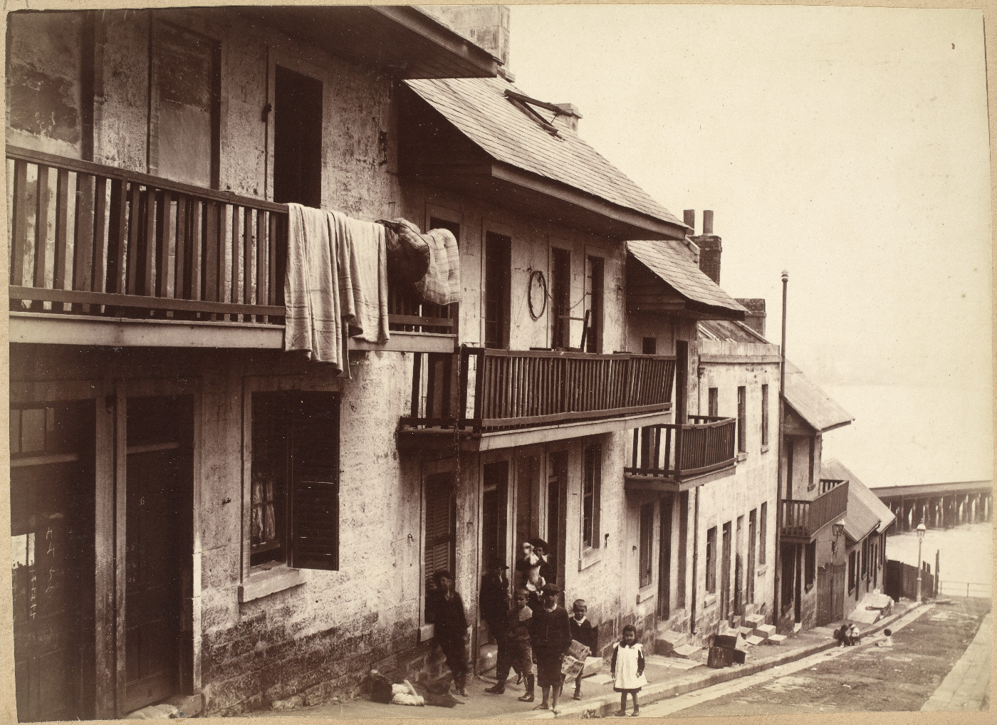 Print - Family outside terraces in Clyde Street Millers Point, 1901 (A-00036190)