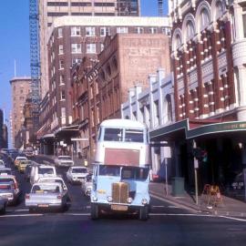 Buss crossing Sussex Street from Market Street Sydney, 1973