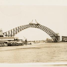 Sydney Harbour Bridge arch near completion from Lavendar Bay, 1930