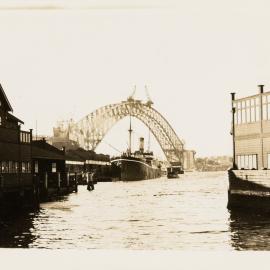 Sydney Harbour Bridge arch meeting during construction from Circular Quay Sydney, 1930